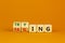 Failing or trying symbol. Turned wooden cubes and changed the word `failing` to `trying`. Beautiful orange background. Busines