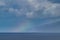 Faint rainbow across the ocean and molokai.