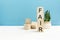 fair - word is written on wooden cubes on a blue background. close-up of wooden elements. in the background is a green