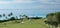 A fairway on a tropical golf course, with a view of the ocean