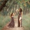 Fairy mother deer on path spinning her daughter on a forest trail, wearing long brown dresses, showing her charming leg