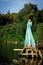 Fairy, princess, goddess of wood in green dress stand outdoors