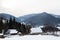 Fairy-tale village Kryvorivnia covered with snow in Carpathians mountains at winter, typical landscape in Hutsulshchyna National