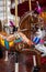Fairytale brown toy horse with purple and pink plumage. Vintage carousel in French style. Retro colorful merry-go-round