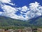 Fairytale clouds over the Alpine peaks and the Bellinzona town with the Ticino river valley