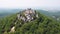 Fairytale medieval old royal castle on mountain, ancient green forest background, top view. AI generated.