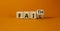 Faith instead fail symbol. Turned a wooden cube and changed the word fail to faith. Beautiful orange table, orange background.