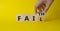 Faith vs Fail symbol. Businessman hand Turnes cube and changes word Fail to Faith. Beautiful yellow background. Business and Faith