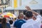 Faithful Catholics raise their hands during the Corpus Christ mass