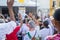 Faithful Catholics raise their hands during the Corpus Christ mass