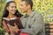 Faithful cheerful young couple being busy with reading bible