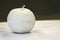 Fake apple colored with white on white paper. Object for drawing classes