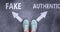 Fake and authentic as different choices in life - pictured as words Fake, authentic on a road to symbolize making decision and