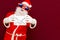 Fake Bearded man in Santa Claus hat holds gift letter envelope box. Ch hristmas gift. Christmas or New Year holidays