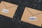 Fake emails or online scams, email envelop icons with real vs fake labels on them