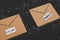 Fake emails or online scams, email envelop icons with real vs fake labels on them