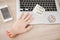 Fake Hand and Smiley Face near Laptop on Table.