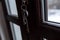 Fake hardwood imitation PVC door close up shot keys on the keyhole, focus on the plastic bar