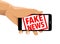 Fake news rubber stamp cell phone