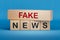 Fake News symbol. Wooden blocks with words \'Fake News\'. Wooden cube blocks.