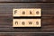 Fake news word written on wood block. fake news text on table, concept