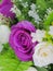 Fake purple rose flowers with artificial water drop.