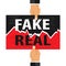 Fake and real sticker on torn paper. Hands break the inscription fake and real.