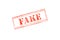 `FAKE` rubber stamp over a white background