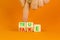 Fake or true symbol. Turned wooden cubes and changed the word fake to true or vice versa. Beautiful orange table, orange