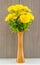 Fake yellow flower in vase.