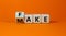 Fake it until you make it symbol. Turned a cube and changed the word `fake` to `make`. Beautiful orange background. Business,