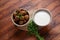 Falafel balls with parsley in wooden bowl with tahini sauce.