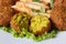 Falafel with French fries, lettuce on a white plate macro