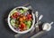Falafel and fresh vegetables salad on dark background, top view. Vegetarian, diet food