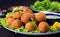 Falafel, hummus and pita. Middle eastern or arabic dishes on a dark background.