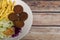 Falafel plate with chips and salad on wooden background with space for text