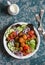 Falafel and vegetables salad bowl. Delicious vegetarian food concept. Buddha bowl on dark background