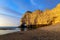 Falaise d`Amont, iconic limestone cliff of Normandy Coast, Etretat, dusk scenery, France