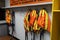 Fall arrest gear and orange high visibility safety vests hanging in the changing-room for stevedores using when aloft of container