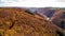 fall autumn aerial view rock with medieval castle Ehrenburg on it near moselle river in Brodenbach with forest hills