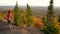 Fall Autumn Foliage Colorful Forest with Woman Walking on Travel Hike. Hiking woman on mountain forest in Mont Tremblant