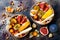 Fall breakfast bowl with chocolate granola, coconut yogurt and autumn seasonal fruits and berries. Healthy vegetarian breakfast