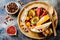 Fall breakfast bowl with chocolate granola, coconut yogurt and autumn seasonal fruits and berries. Healthy vegetarian breakfast