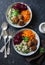 Fall buddha bowl. Bulgur, spinach, meatballs, beets, carrots - balanced healthy eating lunch. On a dark background, top view