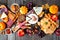 Fall charcuterie table scene against a dark wood background