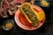 Fall colors with Butternut Squash Boat filled with ground beef with sliced olives on a red plate with some red pepper flakes on t