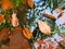 Fall colors. Detail of rotten old leaves on basalt gravel in mirrored water