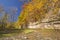 Fall Colors and a Limestone Cliff over a Quiet Stream.