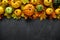 Fall dark stone background with autumn leaves and little pumpkins, top view and copy space