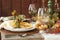 Fall dining place settings on rustic table and wall